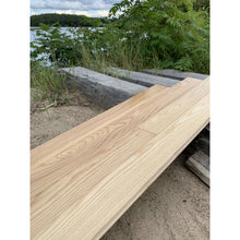 Load image into Gallery viewer, Pre-finished White Ash Flooring on display in front of the Madawaska River